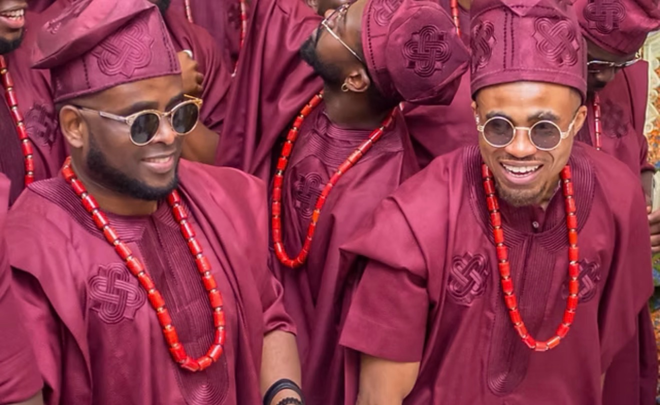 Groomsmen in matching wine agbadas with coral beads